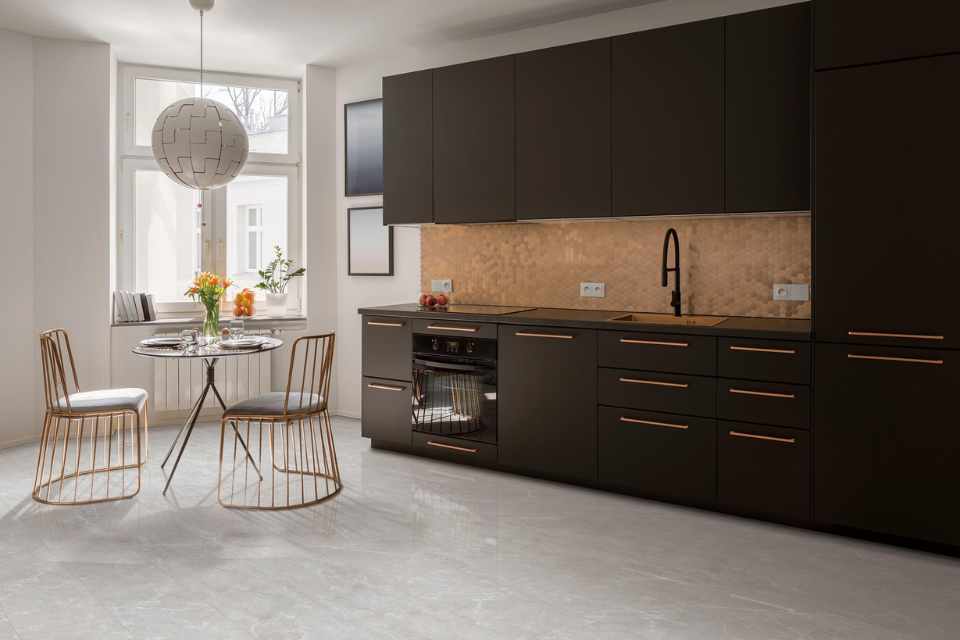 stone look luxury vinyl in modern industrial kitchen with gold finishes